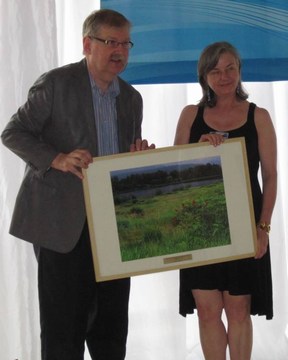 Louise rowell receives award from dan johnston
